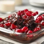 Delicious Black Forest Dump Cake topped with whipped cream and cherries