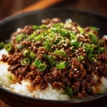 Korean ground beef bowl topped with veggies and sesame seeds