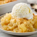 Delicious Pineapple Dump Cake served on a plate with a fork.