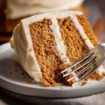 Delicious homemade spice cake with creamy frosting on a plate