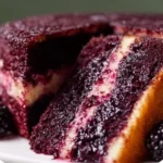 Slice of dreamy blackberry velvet cake with frosting and blackberries