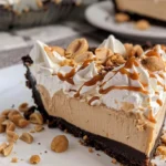 No bake peanut butter pie topped with whipped cream and chocolate drizzle
