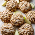 Apple Oatmeal Cookies drizzled with Maple Icing on a rustic wooden table