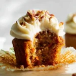 Carrot cake cupcakes with cream cheese frosting on a decorative plate