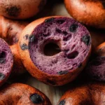 Homemade blueberry bagels with fresh blueberries and a shiny crust