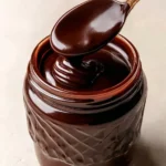 Delicious homemade hot fudge sauce poured over ice cream