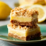 Homemade lemon oat bars with a zesty glaze on a wooden table