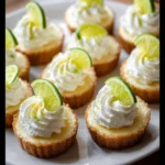 Tequila Lime Mini Cheesecakes topped with lime slices and tequila-infused cream.