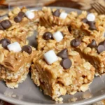 Chocolate peanut butter rice crispy treats topped with drizzled chocolate