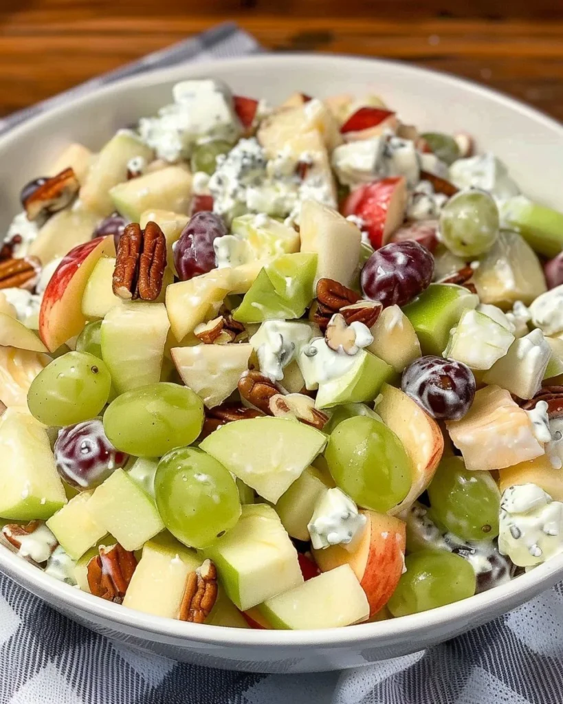 Fruit salad topped with a creamy sour cream dressing and fresh fruit slices.