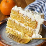 Slice of Mandarin Orange Cake with Pineapple Frosting on a plate