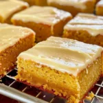 Slice of Pumpkin Sheet Cake topped with rich Brown Butter Icing