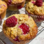 Freshly baked Raspberry Oatmeal Muffins cooling on a rack